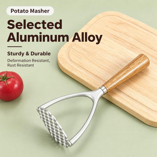Potato masher with oak handle and perforated aluminum head resting on a wooden cutting board