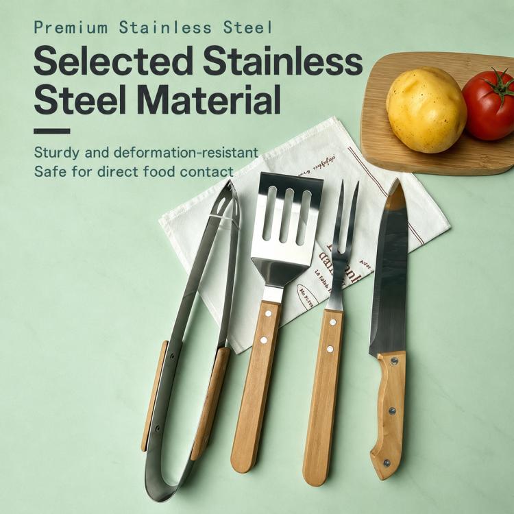 Stainless steel BBQ tools set with wooden handles on a table