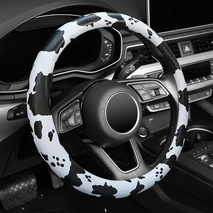 Cow print steering wheel cover with black and white spot and paw-print pattern