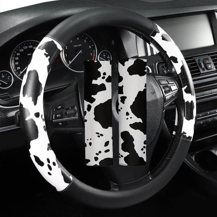 Cow print steering wheel cover with central cutout and black-and-white spotted pattern