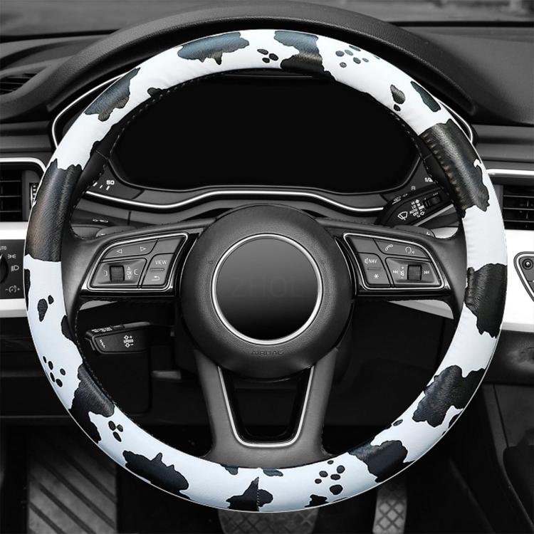 Cow print steering wheel cover covering wheel controls and front rim spokes