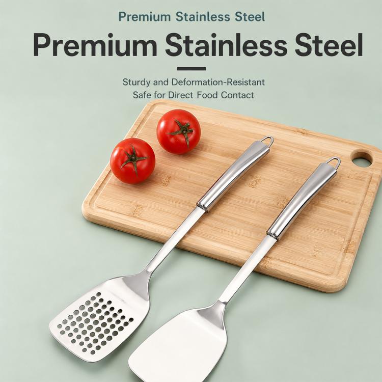 Stainless steel slotted and solid spatulas on a cutting board for everyday cooking
