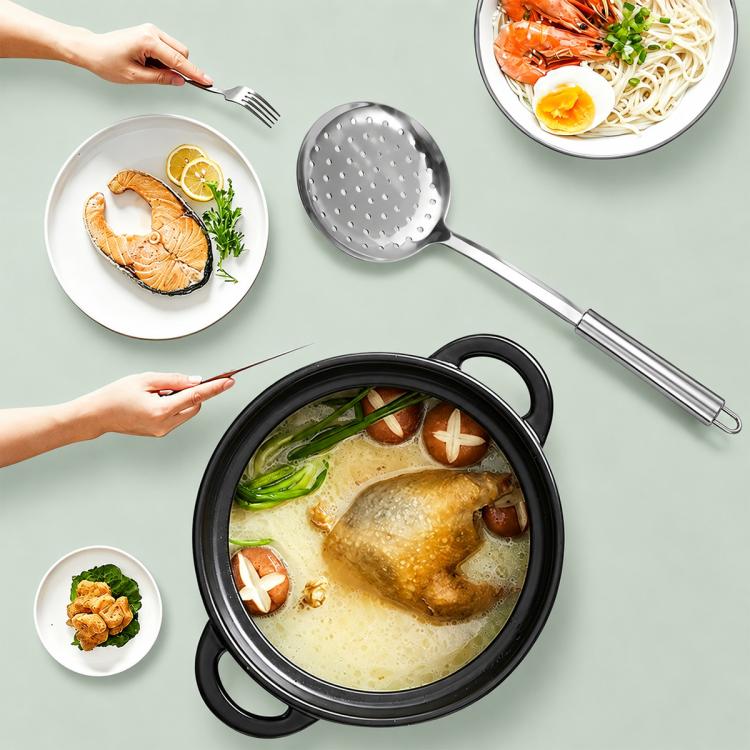 Stainless steel soup ladle with perforated head above a pot
