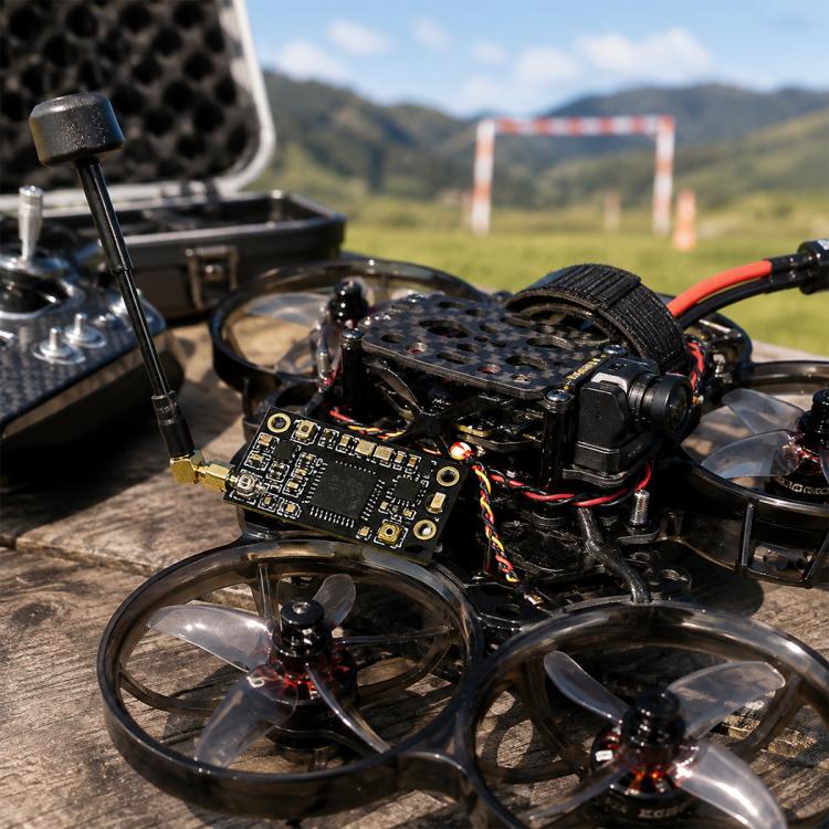 FPV drone with small black receiver circuit board mounted near the frame