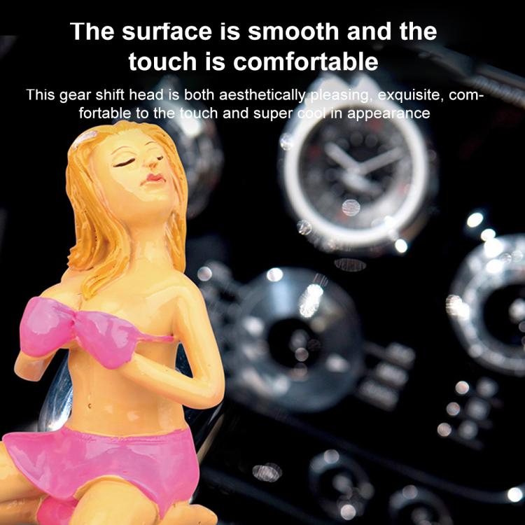 Car manual gear shift knob with glossy pink bikini figure topper close-up