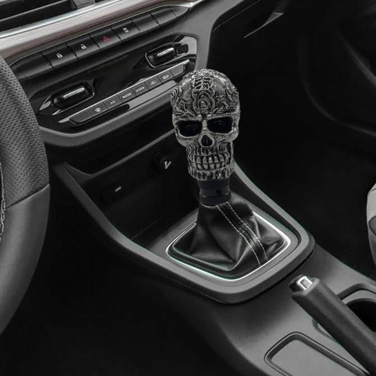 Gray skull-style manual gear shift knob with ornate texture