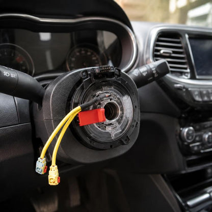 Steering wheel clock spring assembly with yellow wire connectors and red plug, black housing