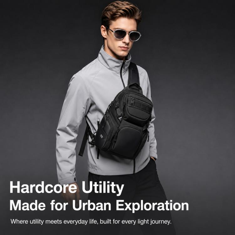 Black crossbody chest bag on a man, showing front zip pocket and side utility straps.