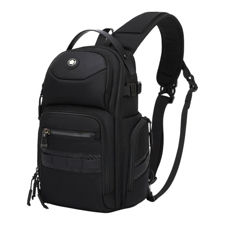 Black crossbody chest bag with top handle, adjustable strap, and front zip pockets.