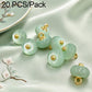 Mint green resin disc buttons with gold loops, glossy finish, small round design