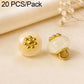 Cream resin floral shank button with gold flower top and gold loop shank