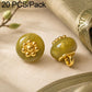 Golden green resin floral shank button with gold flower top and gold loop shank