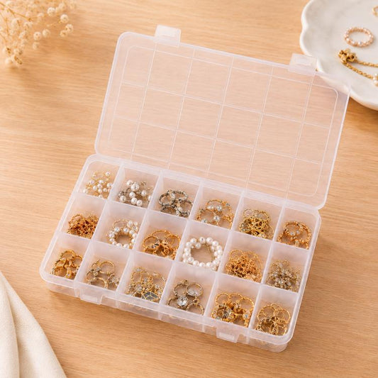 Clear plastic organizer box with lid, open to 18 small compartments holding jewelry