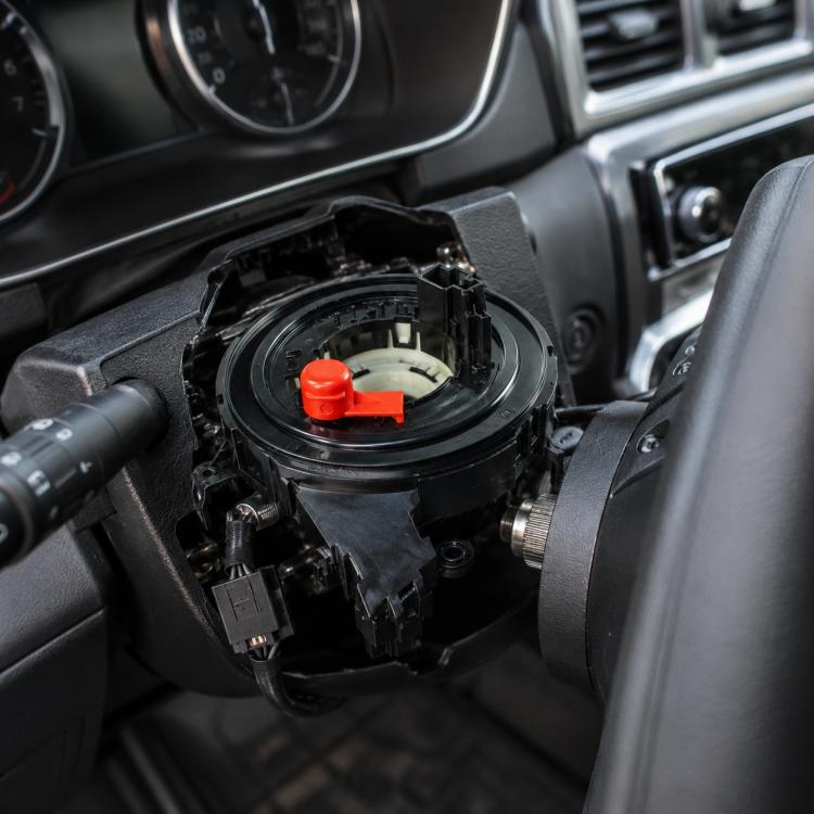 Car steering wheel airbag clock spring spiral cable with red release tab, black housing