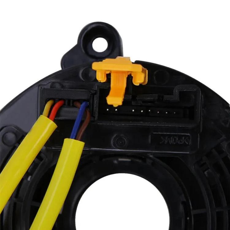 Steering wheel clock spring connector with yellow wiring inside black housing