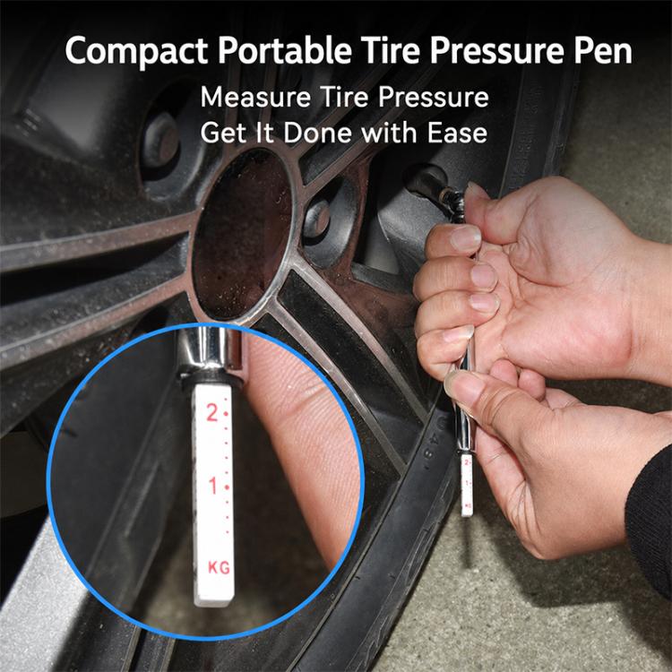 Hand holding a tire pressure gauge pen to the tire valve to measure pressure.
