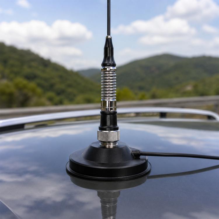 Magnetic vehicle antenna base with black mount and coax cable connection on roof