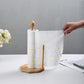 Bamboo paper roll holder with white patterned roll and round wooden base