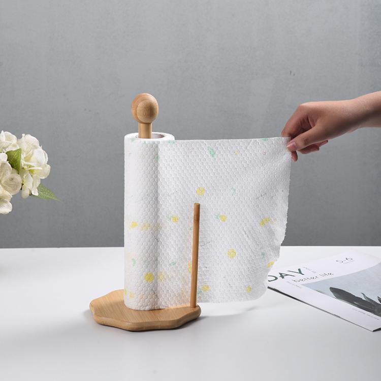 Bamboo paper roll holder with white patterned roll and round wooden base
