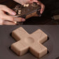 Dark brown wireless game controller close-up with cross-shaped D-pad and rear grip