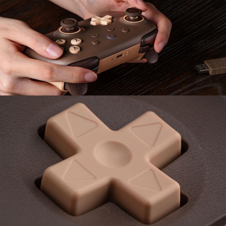 Dark brown wireless game controller close-up with cross-shaped D-pad and rear grip