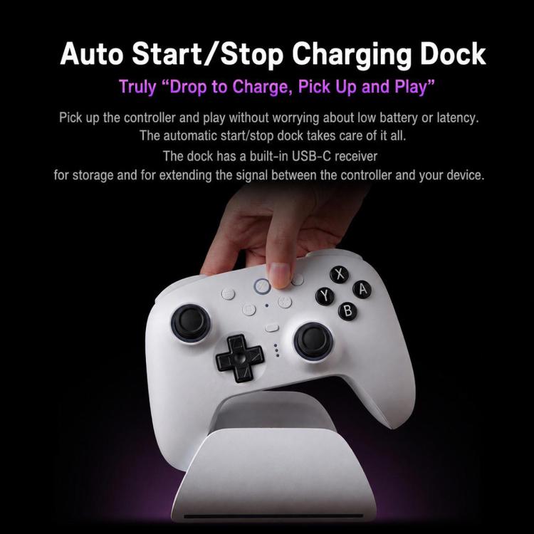 White 8BitDo controller resting in charging dock with thumbstick and face buttons visible