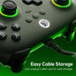 Close-up of dark wired controller with green glowing ring and connected cable