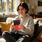 Person holding a red silicone protective case for a handheld game console