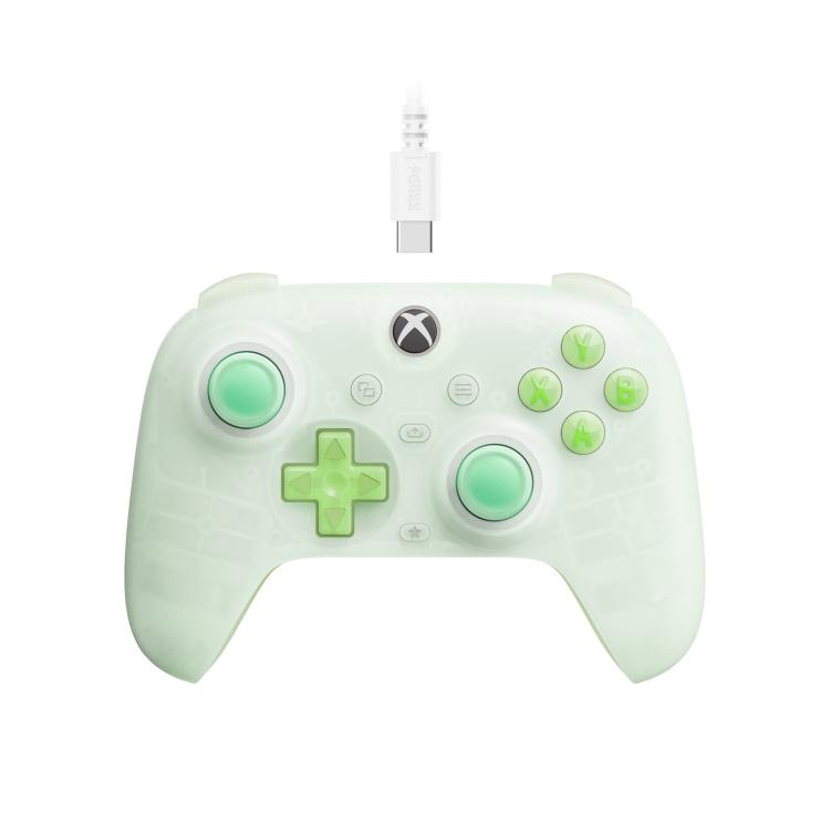 Translucent green wired gaming controller with soft mint buttons and glowing thumbsticks
