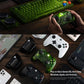 Green wireless game controller held in hand with dual thumbsticks and face buttons