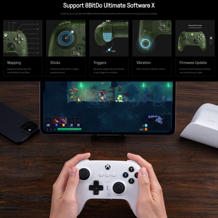 White wireless game controller in hands with dual thumbsticks and face buttons