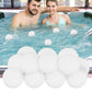 Four white sponge filter balls floating in hot tub water