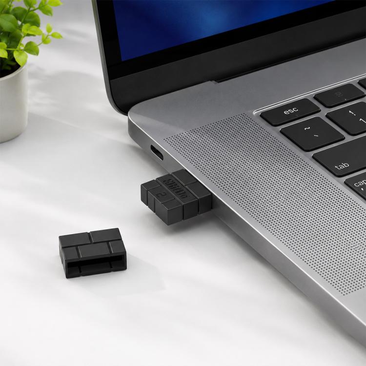 Black 8BitDo USB wireless Bluetooth receiver plugged into a laptop USB port.