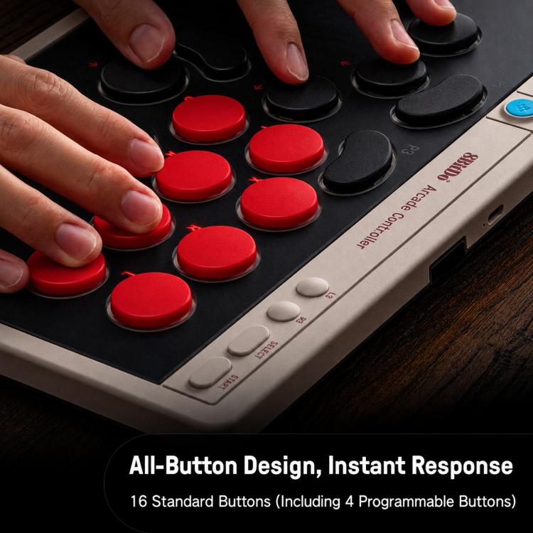 Arcade controller close-up with red buttons and black face controls, showing fingertips on top