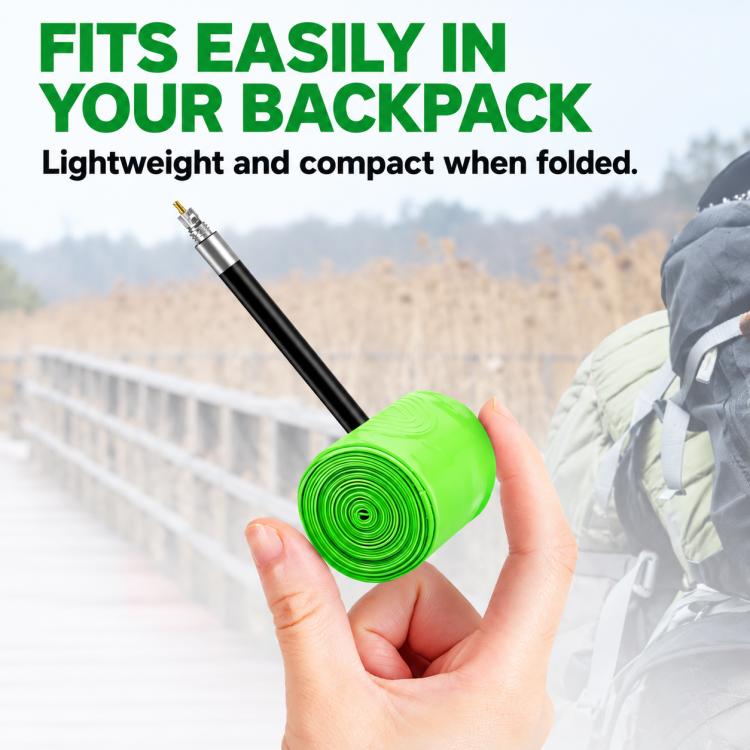 Rolled green TPU bicycle inner tube held in hand, with Presta valve