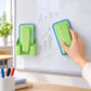Green magnetic spray board eraser with detachable washable pad, held to wipe board marks