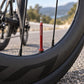 Red Presta tubeless valve extender on bicycle wheel rim, aluminum, 45–85mm