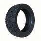 Black 11-inch tubeless scooter tire with deep tread pattern, single tire
