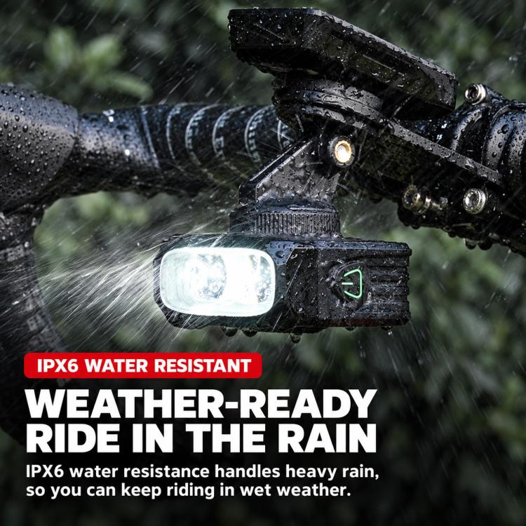 Weather-resistant bike front headlight with beam on rainy road in spray
