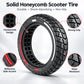 Solid honeycomb-pattern scooter tire with black tread, red side stripe, grip texture