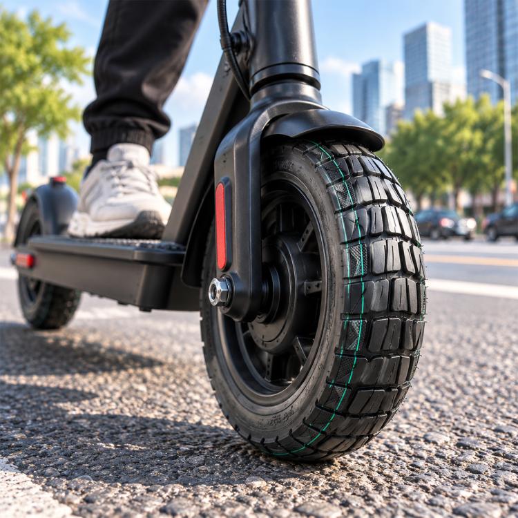 Electric scooter off-road tire, black with teal tread lines, wheel close-up