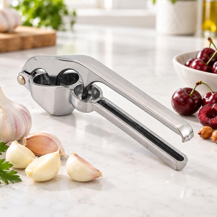 Stainless steel manual garlic press with double press channels and side hinge for squeezing
