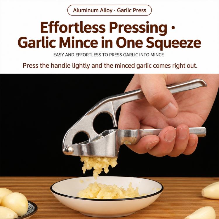 Garlic press tool squeezing minced garlic from perforated plate, shown in hand use