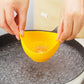 Yellow silicone egg poacher cup held over simmering water by two hands
