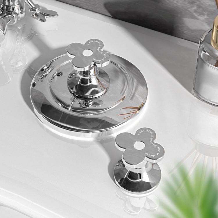 Pair of flower-shaped silver toilet flush button pushers with round center holes