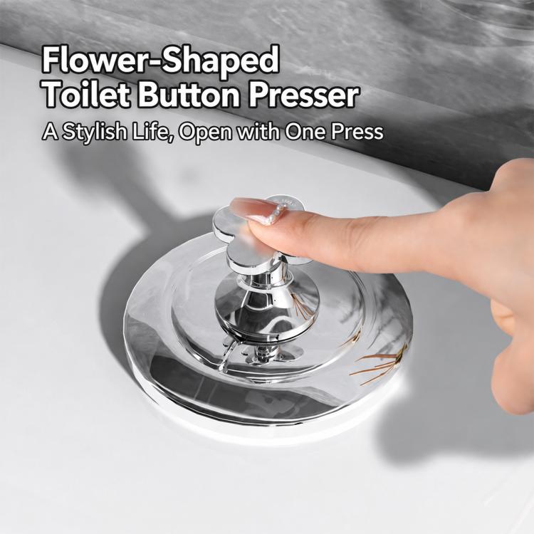 Flower-shaped silver toilet flush button pusher pressed by a hand