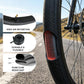 Black bicycle inner tube next to tire tread, valve stem visible