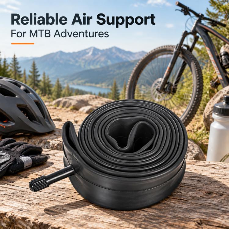 Black bicycle inner tube coil with valve stem, resting on wooden surface