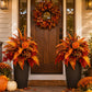 Two orange-red fall floral garden stake arrangements near the entry, each with three stakes