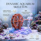 Dynamic aquarium skeleton ornament with orange waterwheel and white figure by bubble-ready hose.